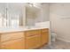 Bright bathroom featuring a vanity with a sink, a mirror, and a shower-tub combo at 7163 S Durango Dr # 108, Las Vegas, NV 89113