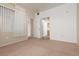 Empty carpeted bedroom with a window, multiple doorways, and base molding at 7163 S Durango Dr # 108, Las Vegas, NV 89113
