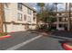 Exterior building view, ample parking, garages, and well-manicured landscaping with palm trees at 7163 S Durango Dr # 108, Las Vegas, NV 89113