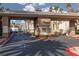 A secure gated entrance featuring well-maintained landscaping and modern architecture for a safe community at 7163 S Durango Dr # 108, Las Vegas, NV 89113