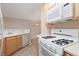 Open kitchen with sleek white appliances, including gas range, microwave and ample counter space at 7163 S Durango Dr # 108, Las Vegas, NV 89113