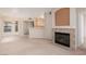Open living area with fireplace, tile flooring, carpet, and partial view into kitchen area at 7163 S Durango Dr # 108, Las Vegas, NV 89113