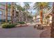 Lush landscaping surrounds the inviting pool area, complete with picnic tables for outdoor enjoyment and relaxation at 7163 S Durango Dr # 108, Las Vegas, NV 89113