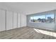 Bedroom featuring a large closet, light wood flooring and a large window with views of the city at 725 N Royal Crest Cir # 237, Las Vegas, NV 89169