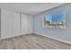 Bedroom featuring a large window with views and wood-style flooring at 725 N Royal Crest Cir # 237, Las Vegas, NV 89169
