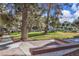 Community common area with sidewalk, shade trees, and bench seating at 725 N Royal Crest Cir # 237, Las Vegas, NV 89169
