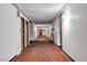 Clean hallway with patterned carpet leading to apartments, offering a welcoming and quiet access at 725 N Royal Crest Cir # 237, Las Vegas, NV 89169