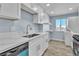 Renovated kitchen with white cabinets, modern countertops, and new stainless steel appliances at 725 N Royal Crest Cir # 237, Las Vegas, NV 89169