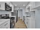 Open kitchen featuring stainless steel appliances, ample countertop space, and wood-style flooring at 725 N Royal Crest Cir # 237, Las Vegas, NV 89169