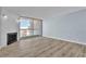 Bright living room featuring wood flooring, modern light-blue paint, and a fireplace with sliding glass doors to the balcony at 725 N Royal Crest Cir # 237, Las Vegas, NV 89169