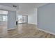 Bright living room featuring wood flooring, modern light-blue paint, a fireplace, and sliding glass doors to the balcony at 725 N Royal Crest Cir # 237, Las Vegas, NV 89169