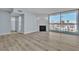 Bright living room featuring wood flooring, modern light-blue paint, and a fireplace with sliding glass doors to the balcony at 725 N Royal Crest Cir # 237, Las Vegas, NV 89169