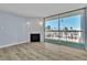 Bright living room featuring wood flooring, modern light-blue paint, and a fireplace with sliding glass doors to the balcony at 725 N Royal Crest Cir # 237, Las Vegas, NV 89169