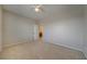 A spacious bedroom with neutral carpet, paint, and a view into another room at 8348 Mokena Ave, Las Vegas, NV 89178