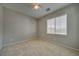 This bedroom has neutral walls and carpet, plus a ceiling fan and bright window at 8348 Mokena Ave, Las Vegas, NV 89178