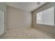 Bedroom features neutral walls and carpet, plus window for natural light and closet at 8348 Mokena Ave, Las Vegas, NV 89178