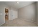 A spacious bedroom featuring carpet and neutral colors, plus a view into the hallway at 8348 Mokena Ave, Las Vegas, NV 89178