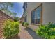 Home exterior with gravel landscaping, healthy green bushes and large window at 8348 Mokena Ave, Las Vegas, NV 89178