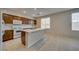 Bright and airy kitchen with a central island, stainless steel appliances, and tile flooring at 8348 Mokena Ave, Las Vegas, NV 89178