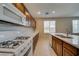 Practical kitchen featuring modern appliances, wooden cabinetry, and neutral countertops at 8348 Mokena Ave, Las Vegas, NV 89178