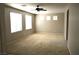 Bright living room with neutral walls, carpet, ceiling fan and multiple windows offering natural light at 8348 Mokena Ave, Las Vegas, NV 89178