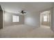 Expansive living room with a ceiling fan, neutral walls, and carpet, offering a comfortable and airy space at 8348 Mokena Ave, Las Vegas, NV 89178