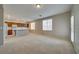 Spacious living room features an open floor plan, with a kitchen area and natural light from the surrounding windows at 8348 Mokena Ave, Las Vegas, NV 89178