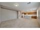 Open-concept living area flowing into a kitchen with wooden cabinets and a marble island, perfect for modern living at 8348 Mokena Ave, Las Vegas, NV 89178