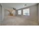 Open-concept living area featuring neutral carpet, staircase, ceiling fan, and bright natural light at 8348 Mokena Ave, Las Vegas, NV 89178