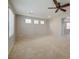 Bright and airy living room with neutral carpet, a ceiling fan, and plenty of natural light at 8348 Mokena Ave, Las Vegas, NV 89178