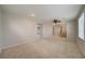 Spacious living room with neutral carpet, ceiling fan, staircase, and ample natural light at 8348 Mokena Ave, Las Vegas, NV 89178