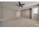 Large main bedroom with neutral carpet, fan, and paint, providing a blank canvas for personalized décor at 8348 Mokena Ave, Las Vegas, NV 89178