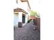View of the side yard with gravel landscaping and a walkway leading to the house entrance at 8348 Mokena Ave, Las Vegas, NV 89178
