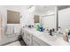 Modern bathroom with dual sinks, sleek vanity, and well-lit mirror for a refreshing start at 8415 Iron Heart Ln, Las Vegas, NV 89113