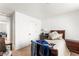 Cozy bedroom with a comfortable bed, soft carpeting and a door leading to another room at 8415 Iron Heart Ln, Las Vegas, NV 89113