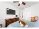 Cozy bedroom with ceiling fan and a wooden dresser at 8415 Iron Heart Ln, Las Vegas, NV 89113