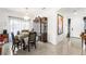 Bright dining room featuring tile floors, chandelier, and decorative china cabinet at 8415 Iron Heart Ln, Las Vegas, NV 89113
