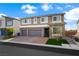 Charming two-story home featuring stone accents, two-car garage, and a well-manicured front lawn at 8415 Iron Heart Ln, Las Vegas, NV 89113