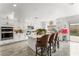 Kitchen with central island, breakfast bar, tile backsplash and stainless steel appliances at 8415 Iron Heart Ln, Las Vegas, NV 89113