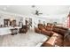 Expansive living room featuring plush leather seating, chandelier lighting, and staircase at 8415 Iron Heart Ln, Las Vegas, NV 89113