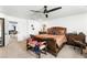 An ample main bedroom featuring comfortable carpets and a ceiling fan at 8415 Iron Heart Ln, Las Vegas, NV 89113