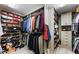 Spacious walk-in closet with custom shelving and ample storage space for clothes and shoes at 8415 Iron Heart Ln, Las Vegas, NV 89113