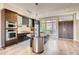Modern kitchen features stainless steel appliances, dark cabinetry and an island with a sink at 8925 W Flamingo Rd # 310, Las Vegas, NV 89147