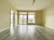 A bright living room featuring laminate flooring, large windows and a sliding glass door to the balcony at 8925 W Flamingo Rd # 310, Las Vegas, NV 89147