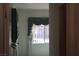 A bedroom with a window dressed with elegant gray and white curtains at 8982 Emerald Waters Ct, Las Vegas, NV 89147