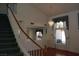 Elegant foyer showcasing a chandelier and a winding staircase with wood and white railing at 8982 Emerald Waters Ct, Las Vegas, NV 89147