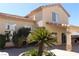 Stucco exterior of a two-story home with well-maintained landscaping and a tiled roof at 8982 Emerald Waters Ct, Las Vegas, NV 89147