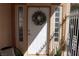 Front door with adjacent sidelight windows and protective, white metal security gate at 8982 Emerald Waters Ct, Las Vegas, NV 89147