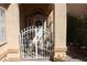 Gated front porch showing front door with wreath and sidelight windows at 8982 Emerald Waters Ct, Las Vegas, NV 89147