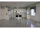 Spacious kitchen featuring white cabinetry, tile countertops, and a central island with bar stools at 8982 Emerald Waters Ct, Las Vegas, NV 89147